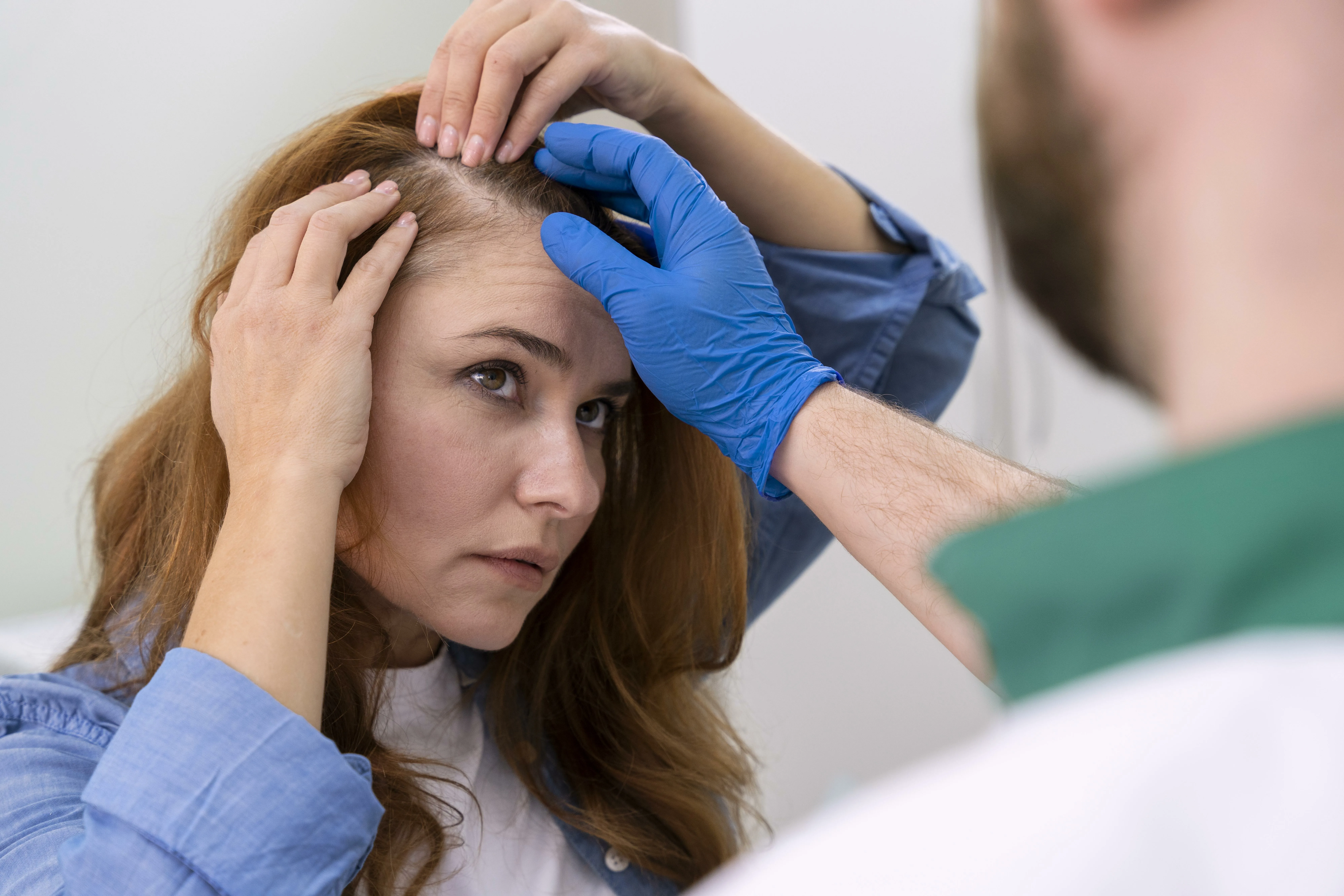 woman getting hair loss treatment clinic jpg